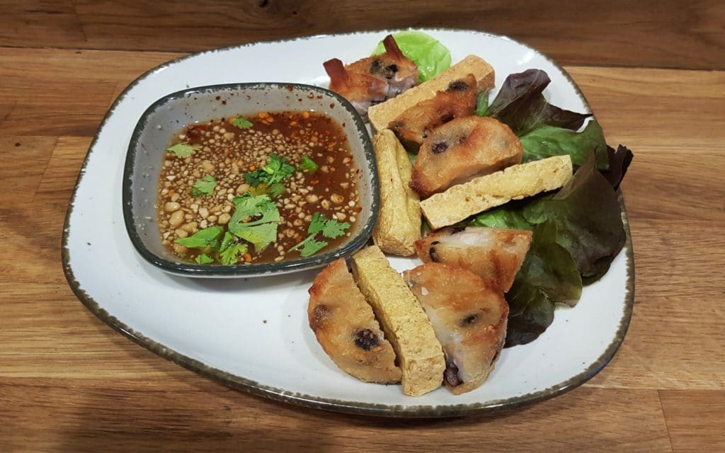 A plate of Thai food Teua Ka Ko, fried cake with taro, tofu, black beans.