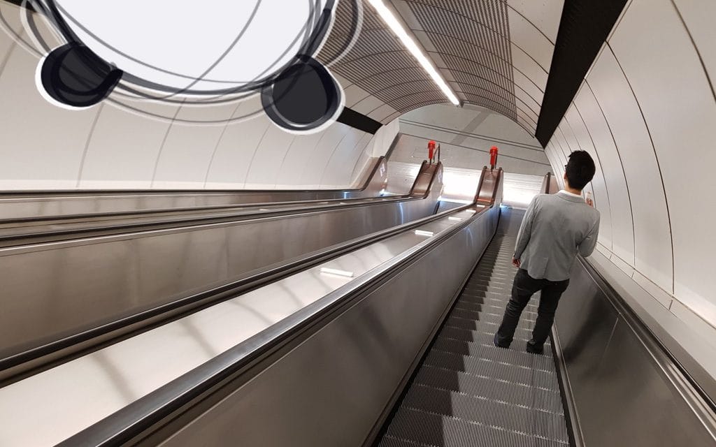 A Viennese standing right on an escalator in a Vienna subway station.